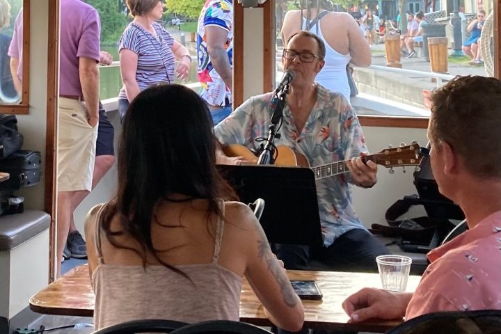 a group of people standing in front of a window