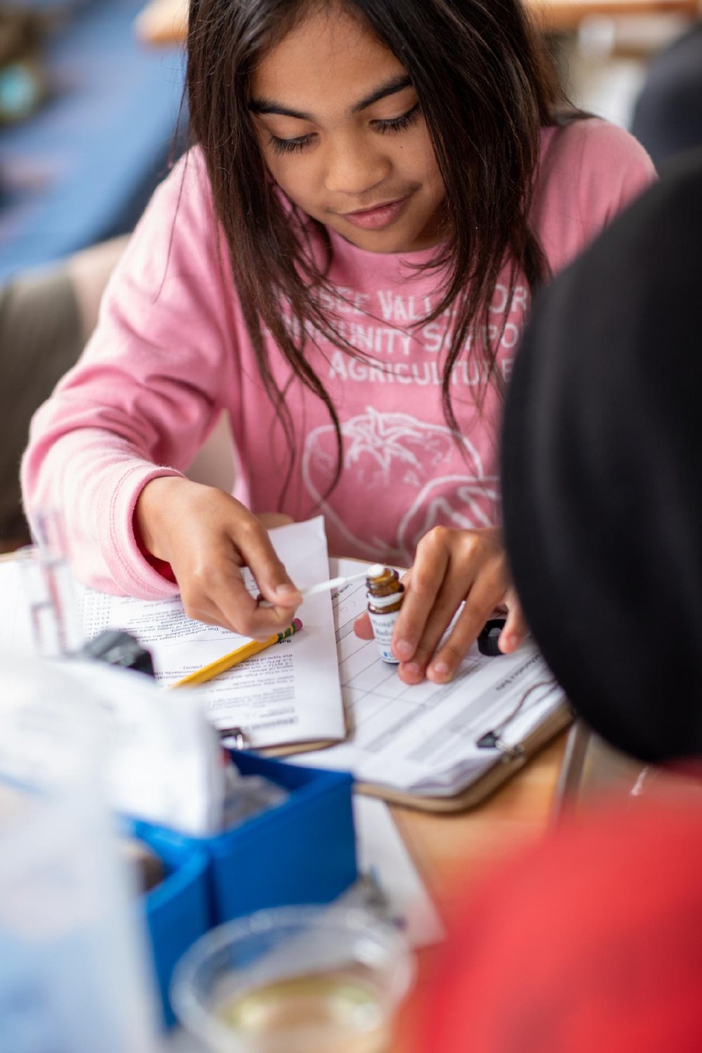a woman sitting at a table using a laptop