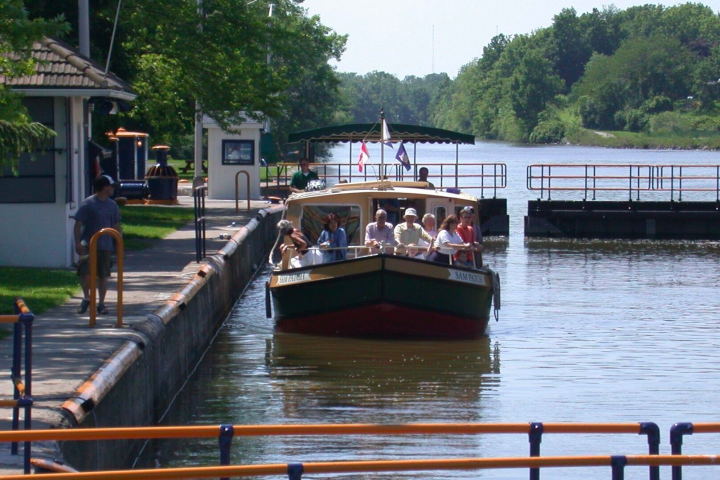 a boat sitting on top of a wooden bridge over a body of water