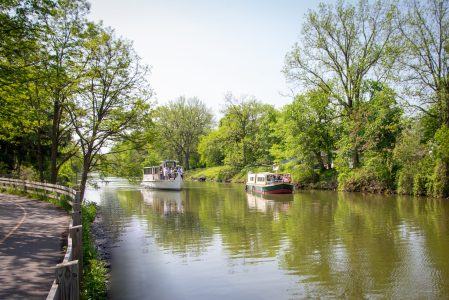 a small boat in a body of water surrounded by trees