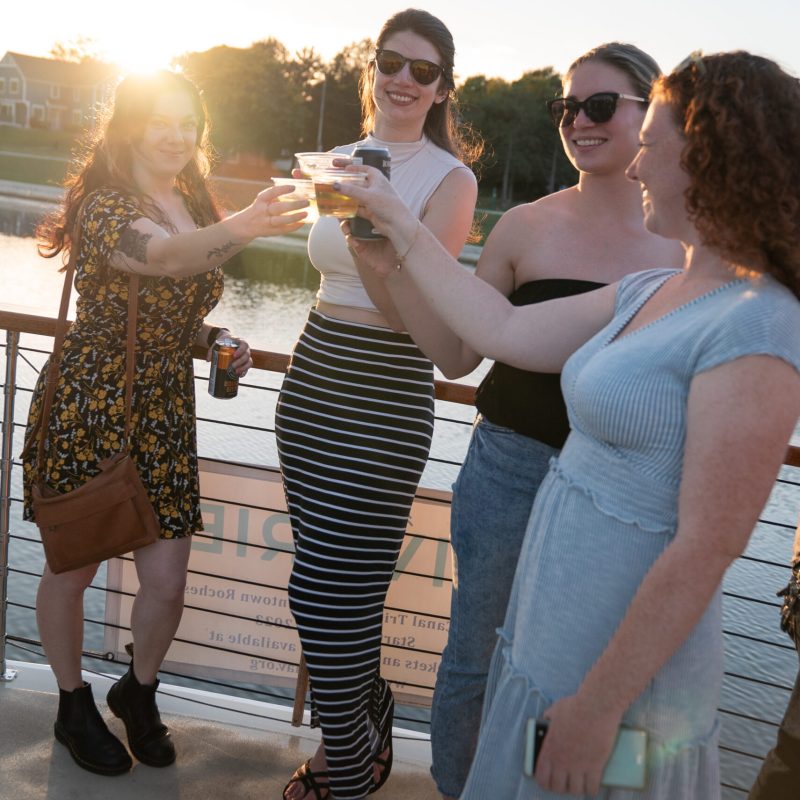 a group of people standing next to a woman