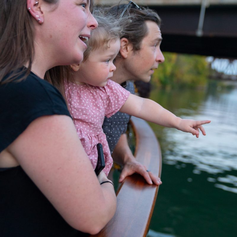a man and a woman looking at the water