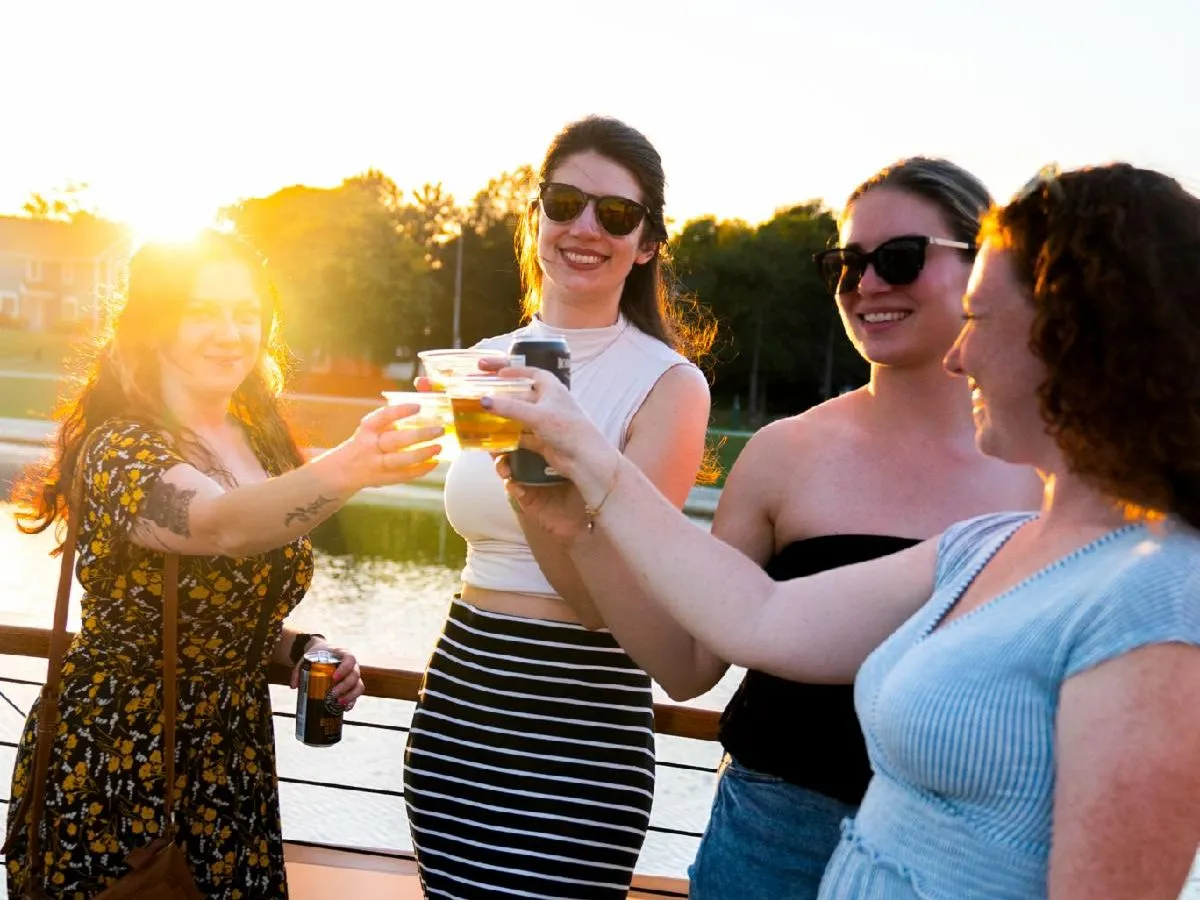 PrivateCharter_Riverie a group of people standing next to a woman