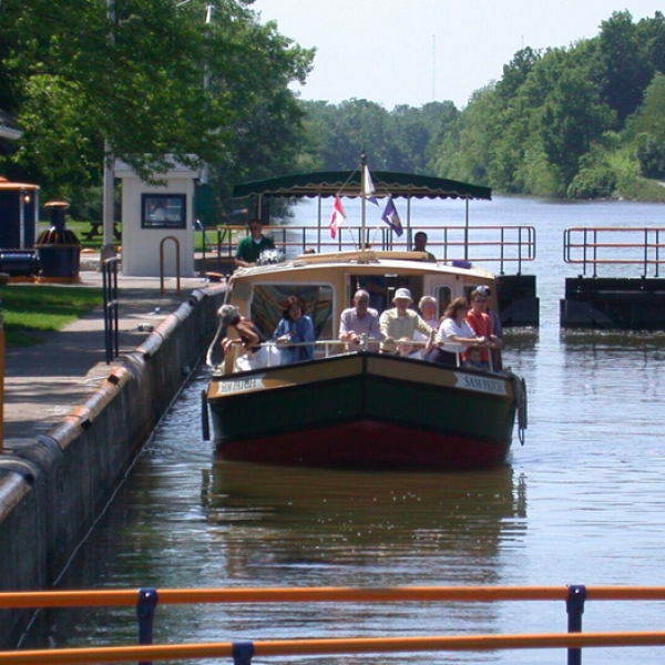 a boat sitting on top of a wooden bridge over a body of water