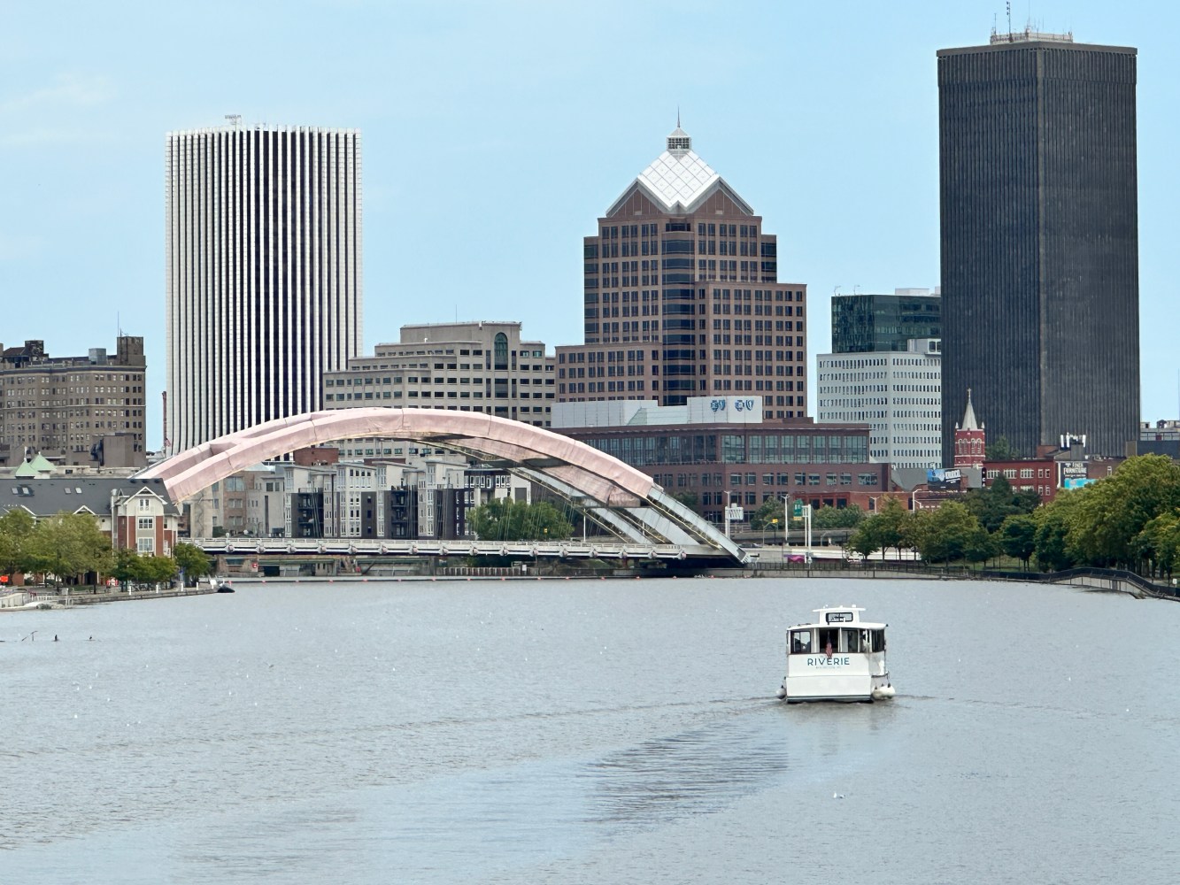 a small boat in a body of water with a city in the background